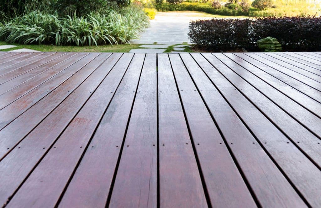 Low-angle dark-stained deck looking out to a landscaped garden path