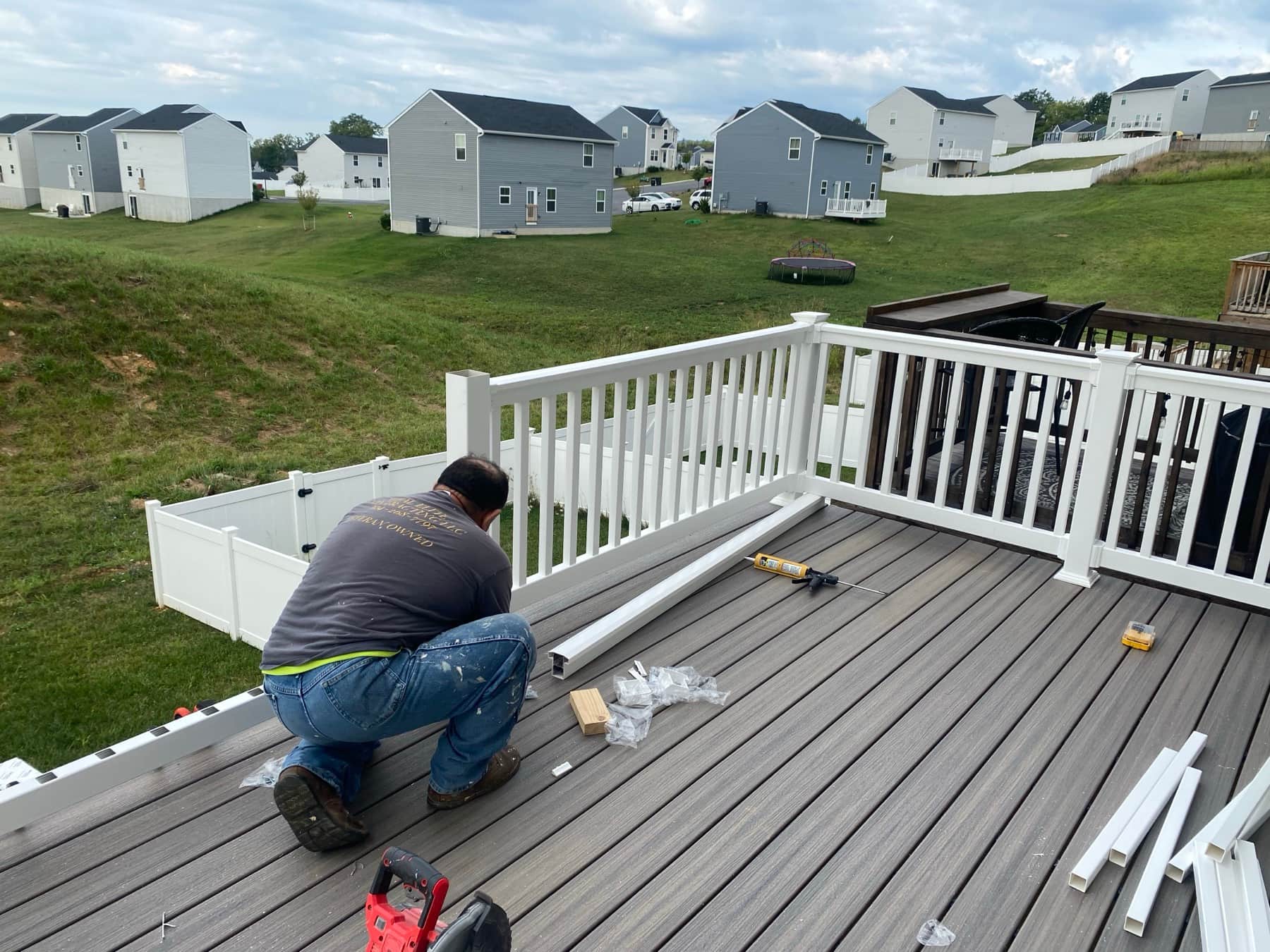 Installing white railing on deck