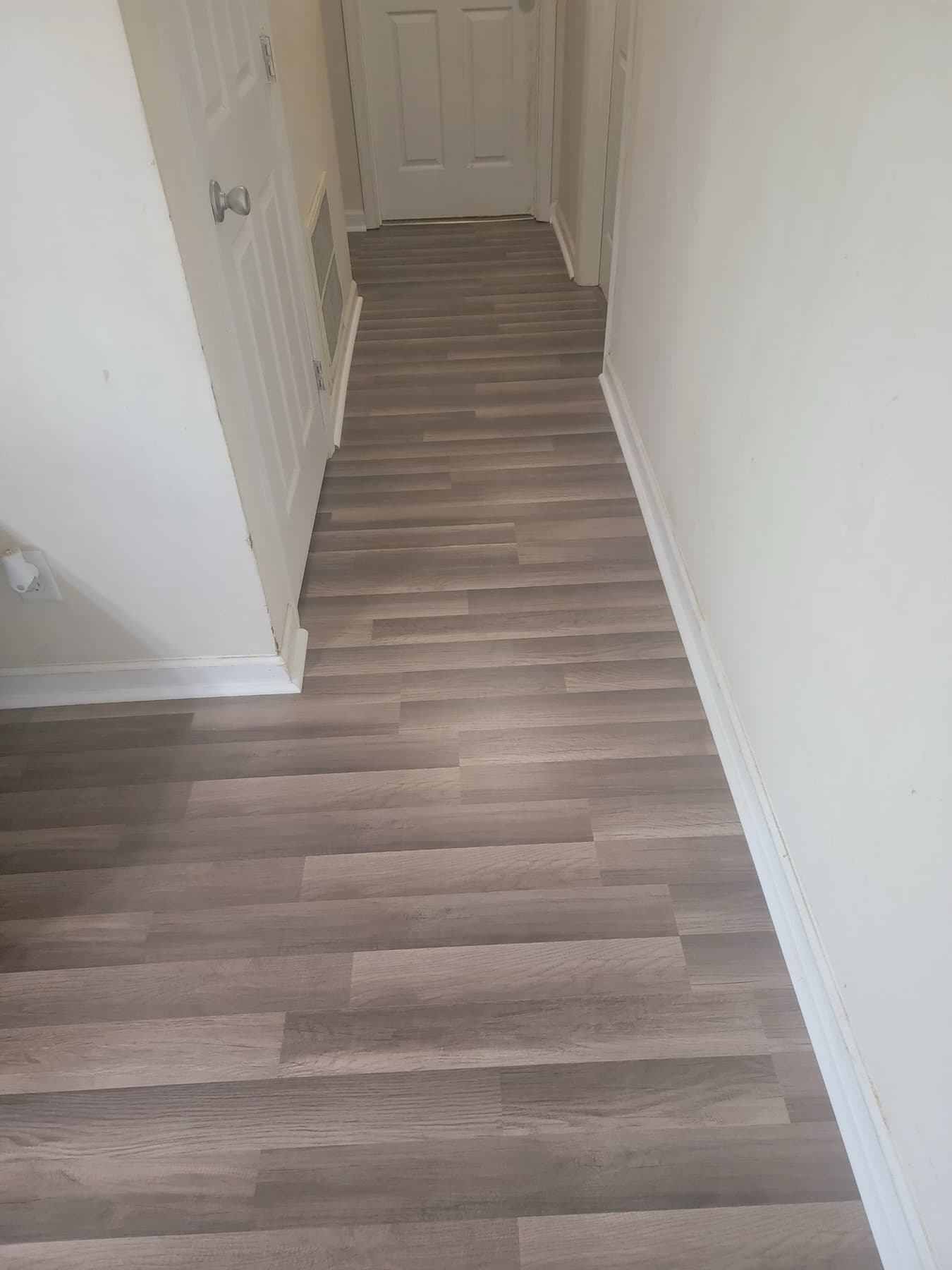 Light wood laminate flooring in hallway