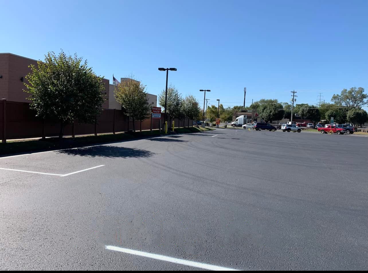 A freshly paved and striped commercial parking lot