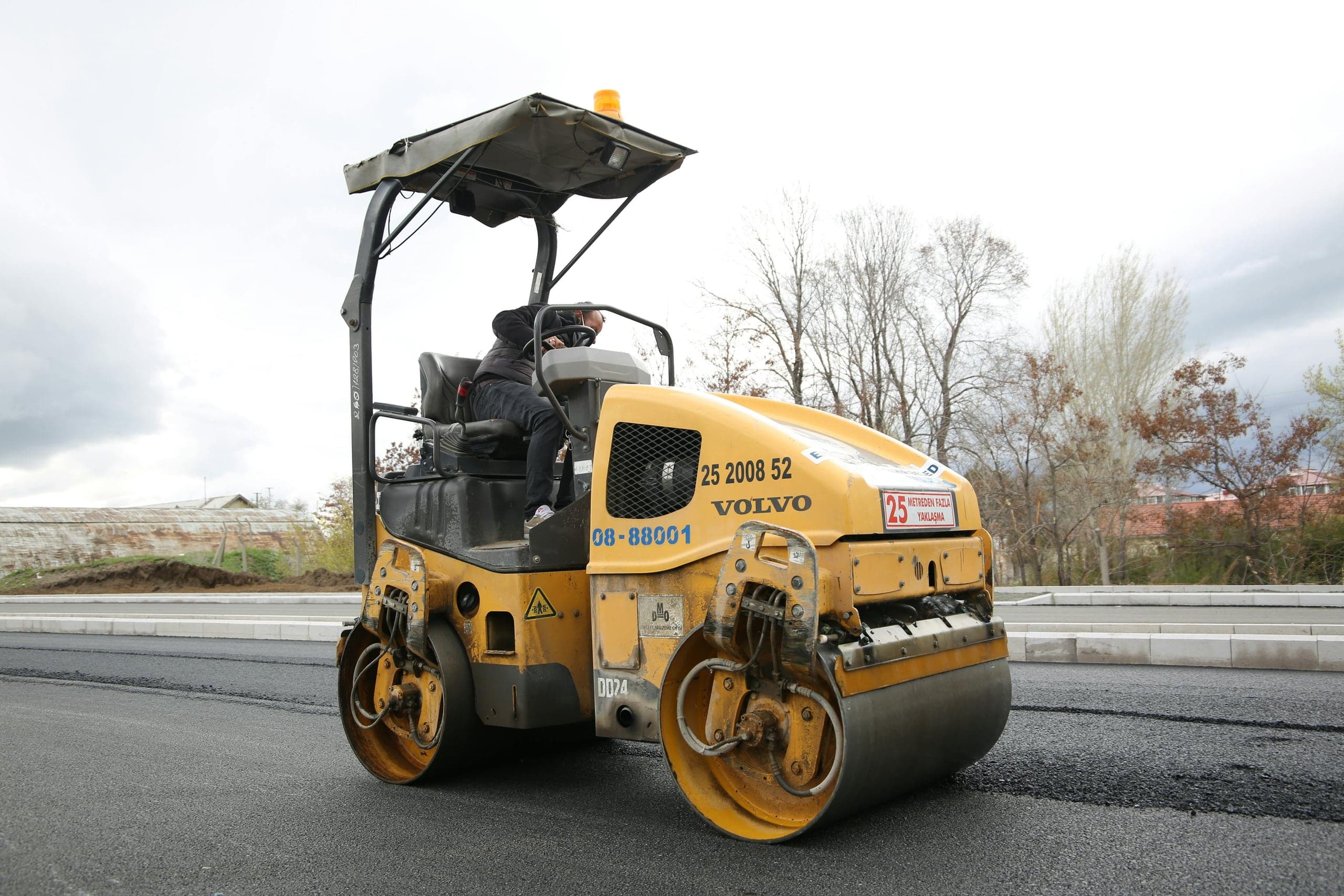 A road roller compacting fresh asphalt