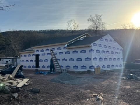 New construction with house wrap at sunset