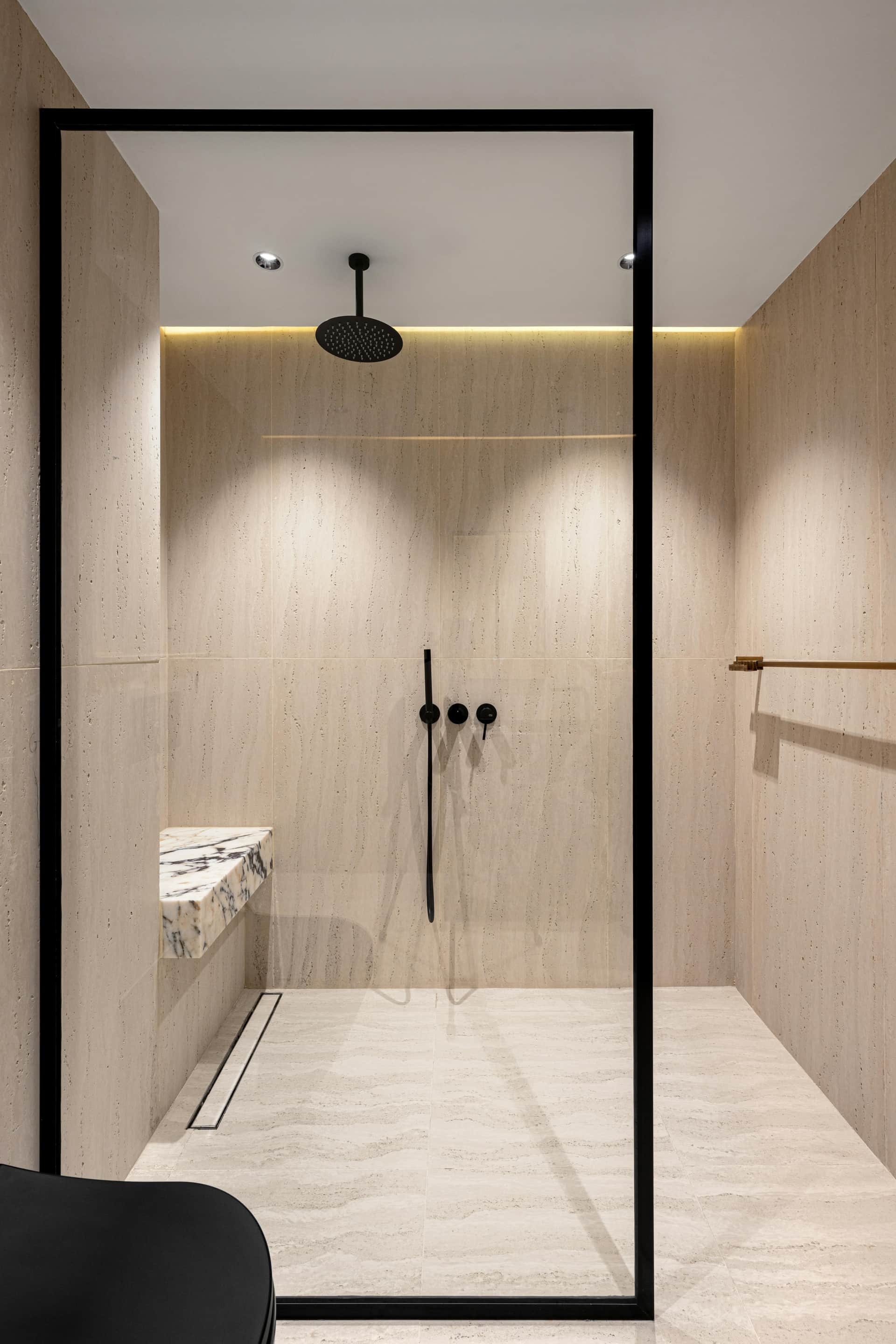 Contemporary walk-in shower with black-frame glass and wood-look tile