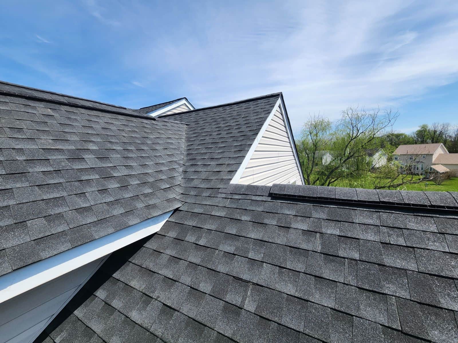 Completed dark architectural shingle roof with clean ridge cap