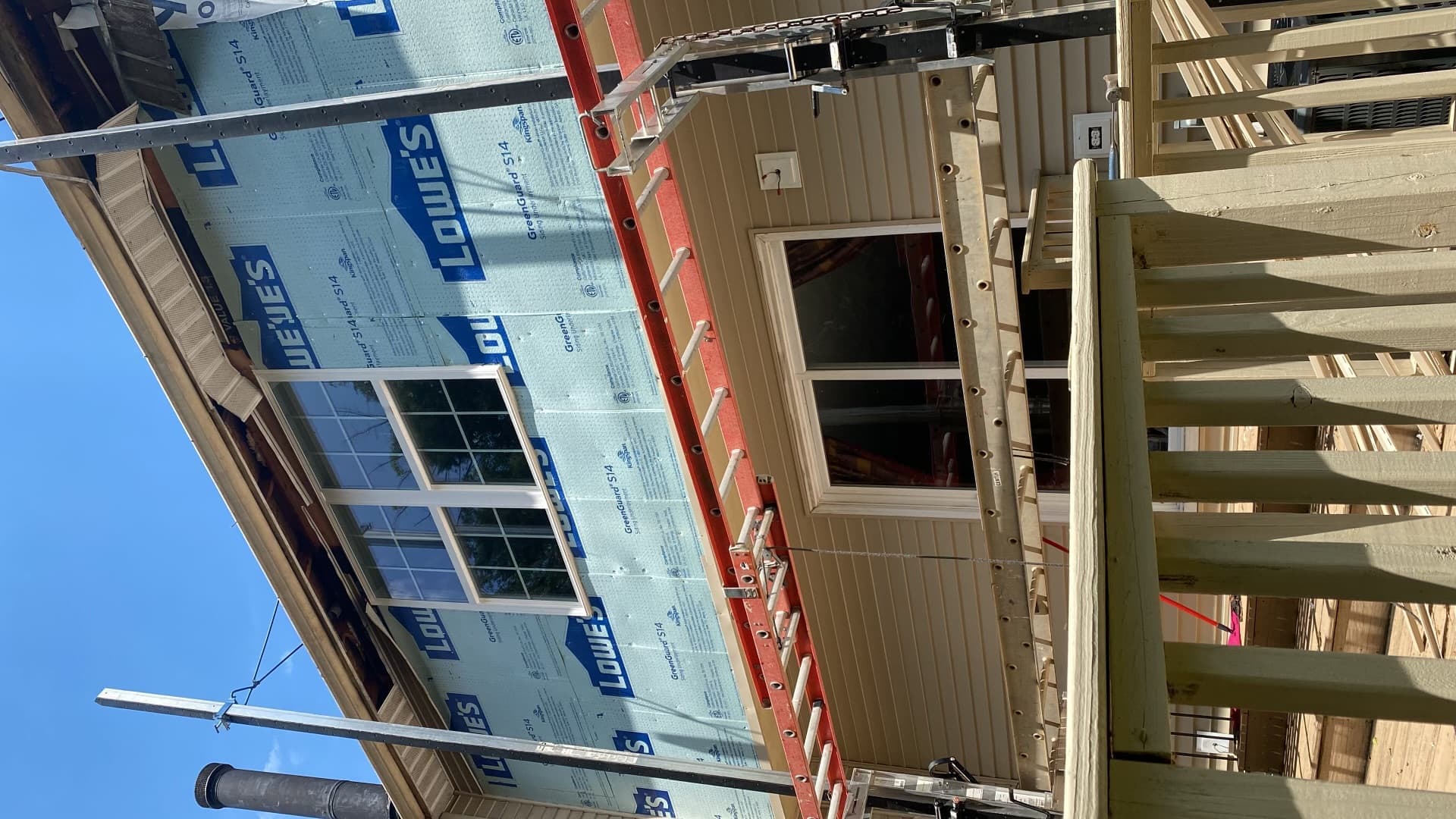 Siding and window replacement showing house wrap to siding transition