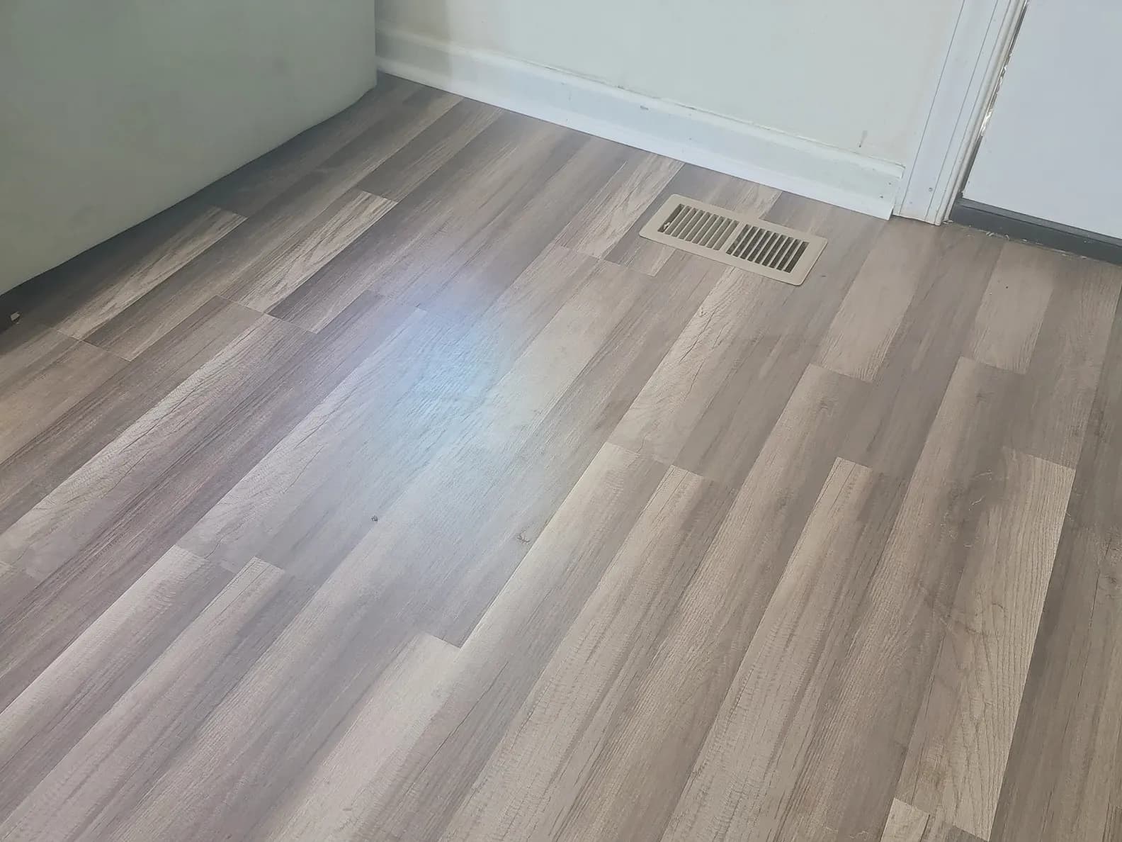 Newly installed light wood-look laminate flooring