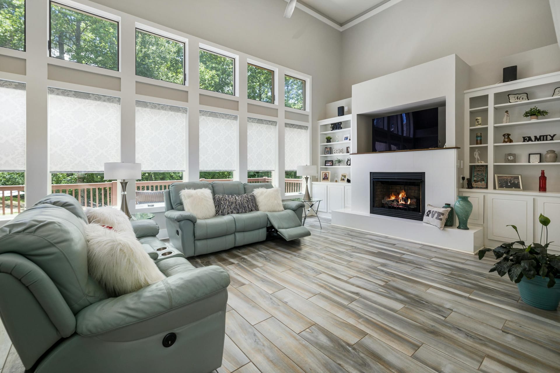 A bright family room with a fireplace and large windows