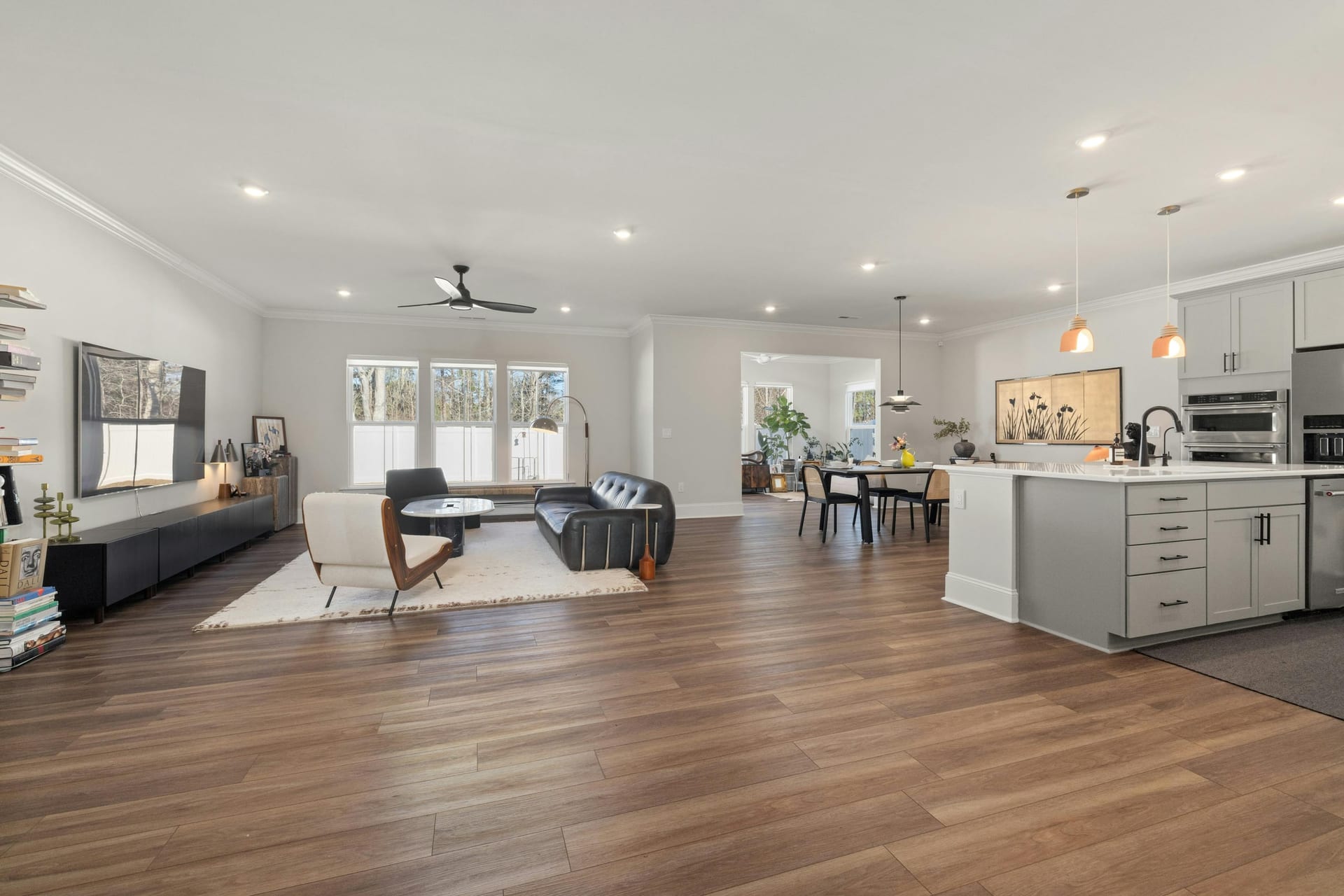 A bright open-concept living space with kitchen and large windows