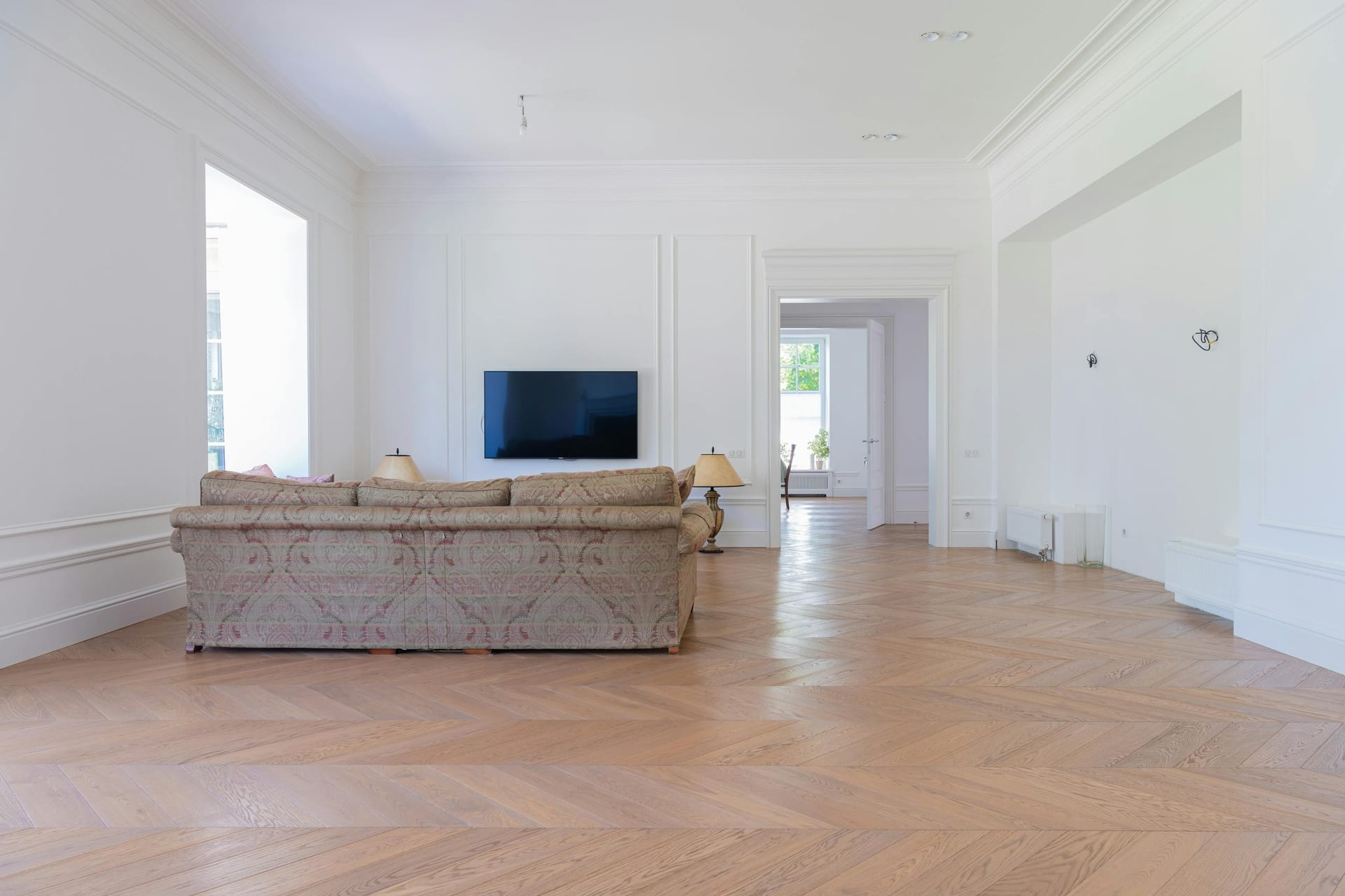 An elegant living room with rich hardwood floors and a luxurious seating area
