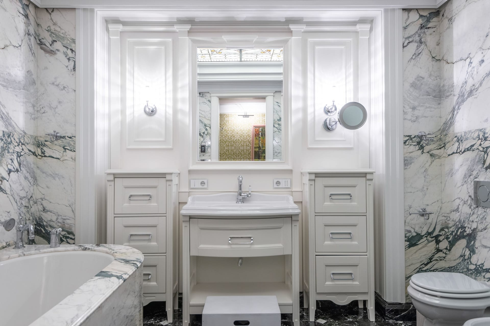 A contemporary bathroom with a double vanity, large mirror, and a glass-walled walk-in shower