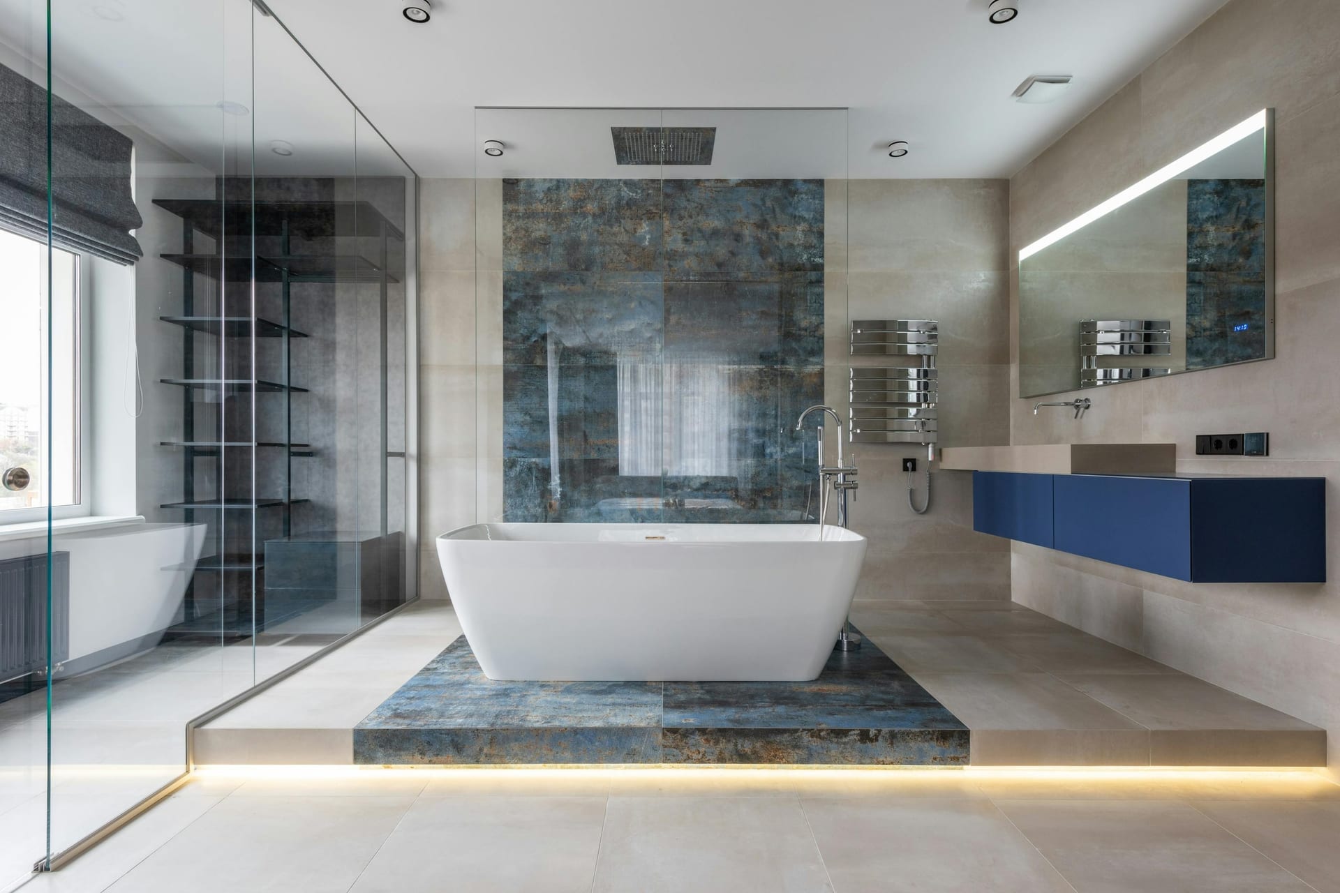 A spa-style bathroom with a freestanding soaking tub beside a large window and warm natural light