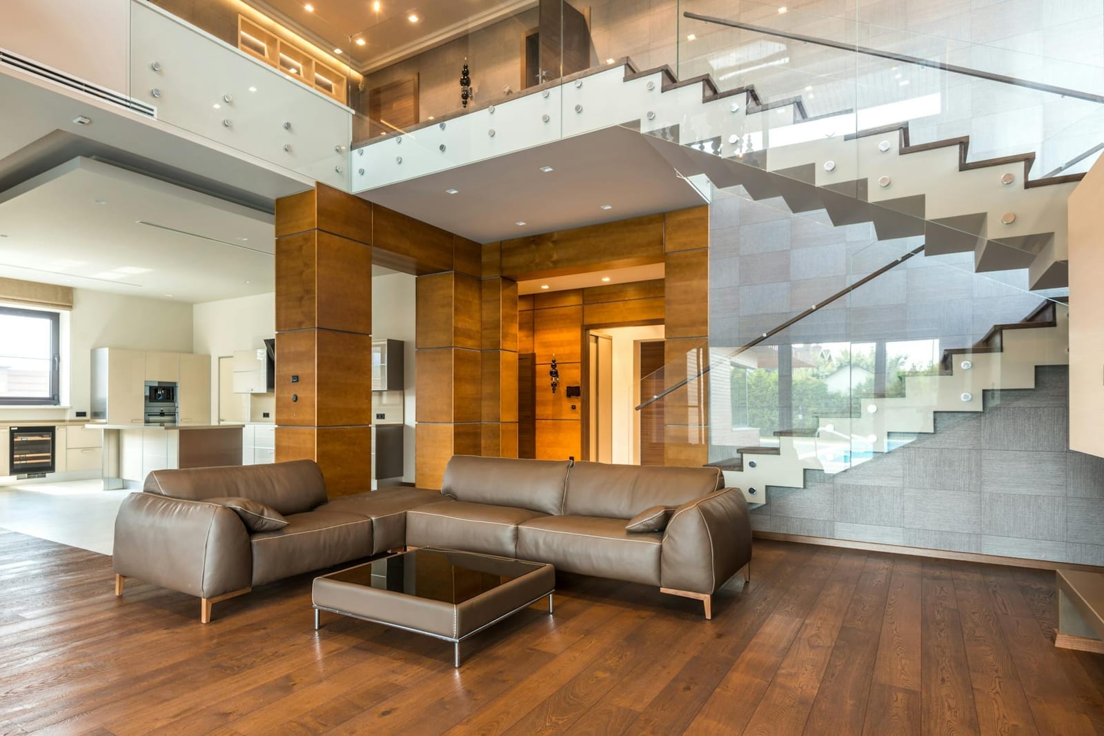 A bright, modern open-concept living room with large windows and contemporary furnishings