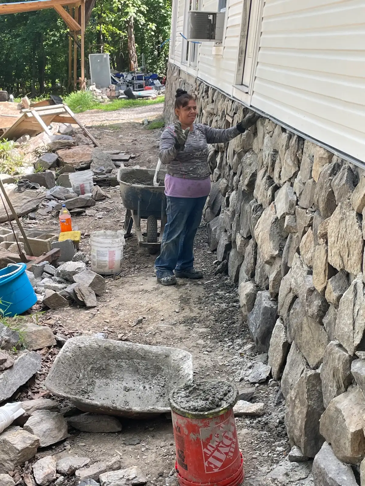Real Elite crew member installing stone veneer on a home exterior