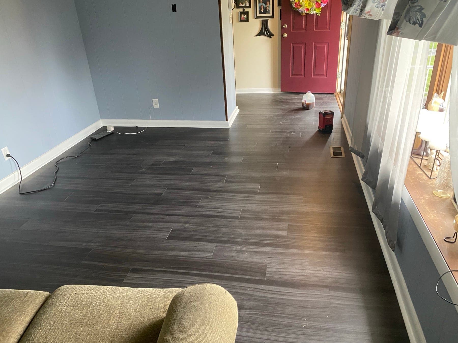 Dark laminate flooring installed in remodeled living room