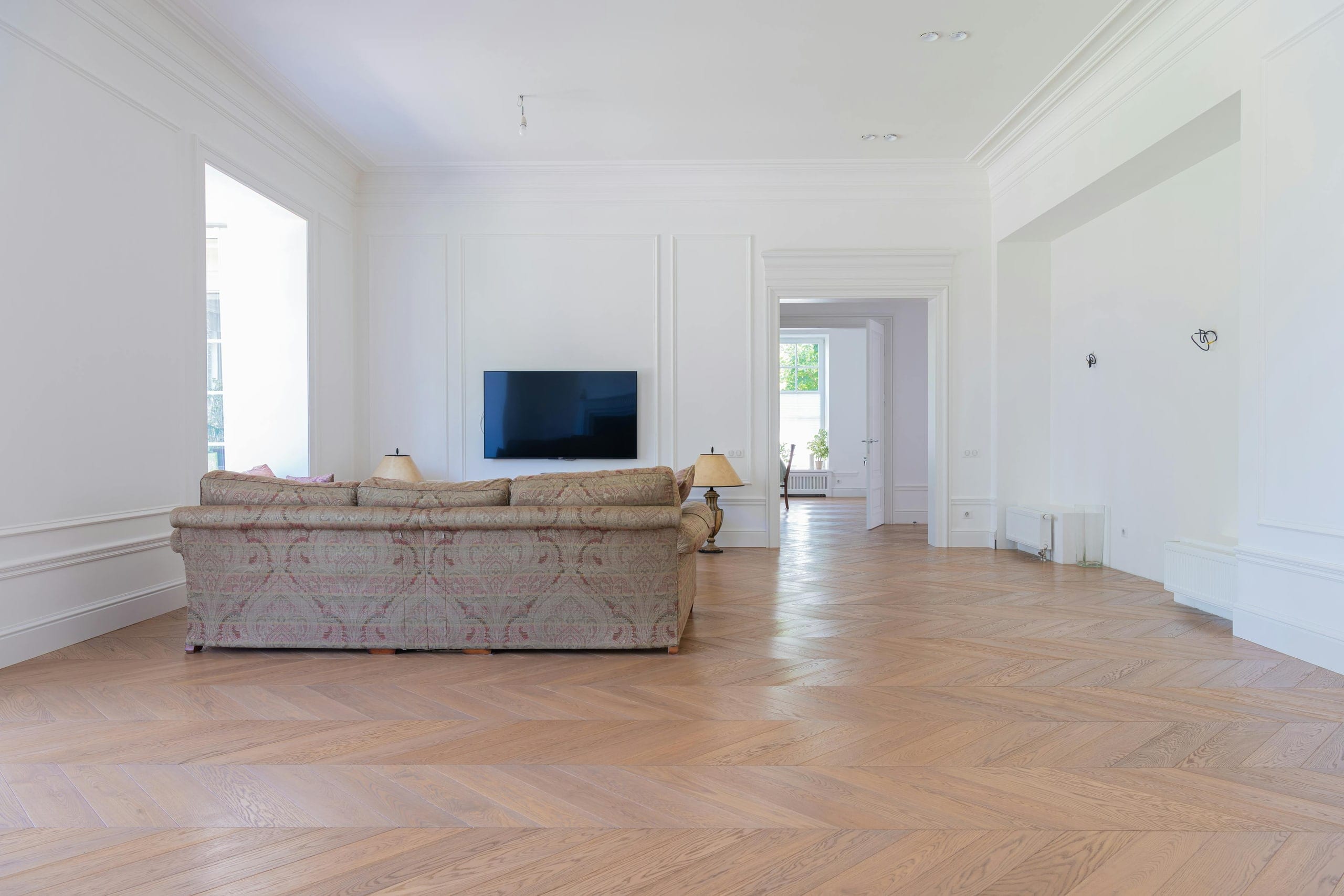 An elegant living room with rich hardwood floors and a luxurious seating area